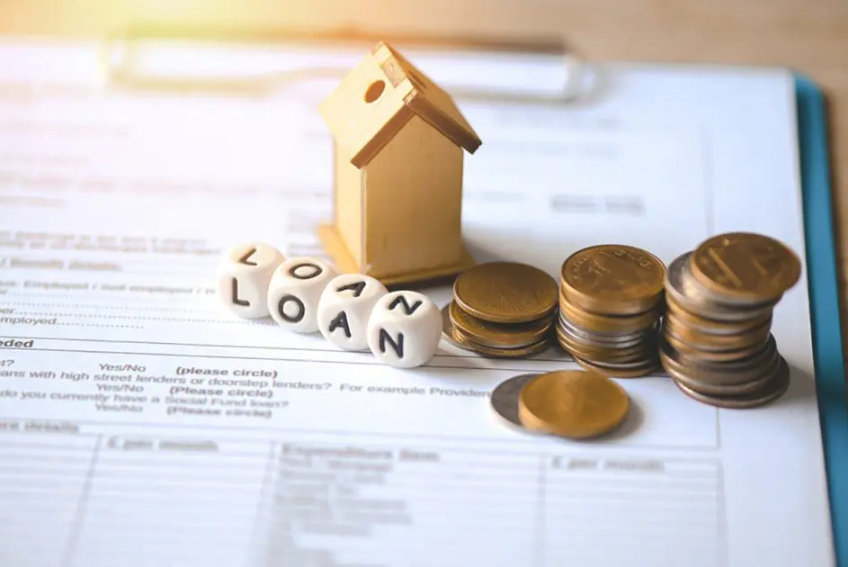 Home loan concept, Loan application form paper with money coin and loan house model on table, Loan business finance economy commercial real estate investments concept