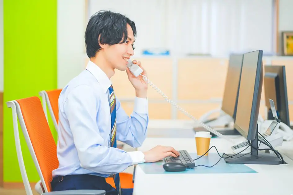 Young businessman on the phone at work